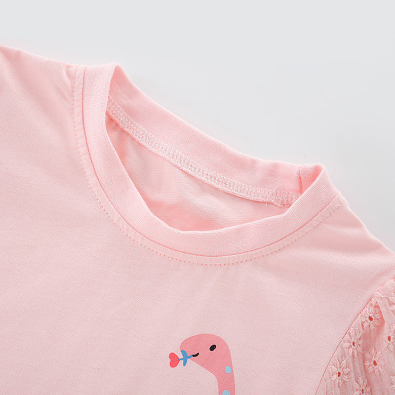 Girls’ pink t-shirt featuring a cartoon dinosaur print, perfect for summer wear.