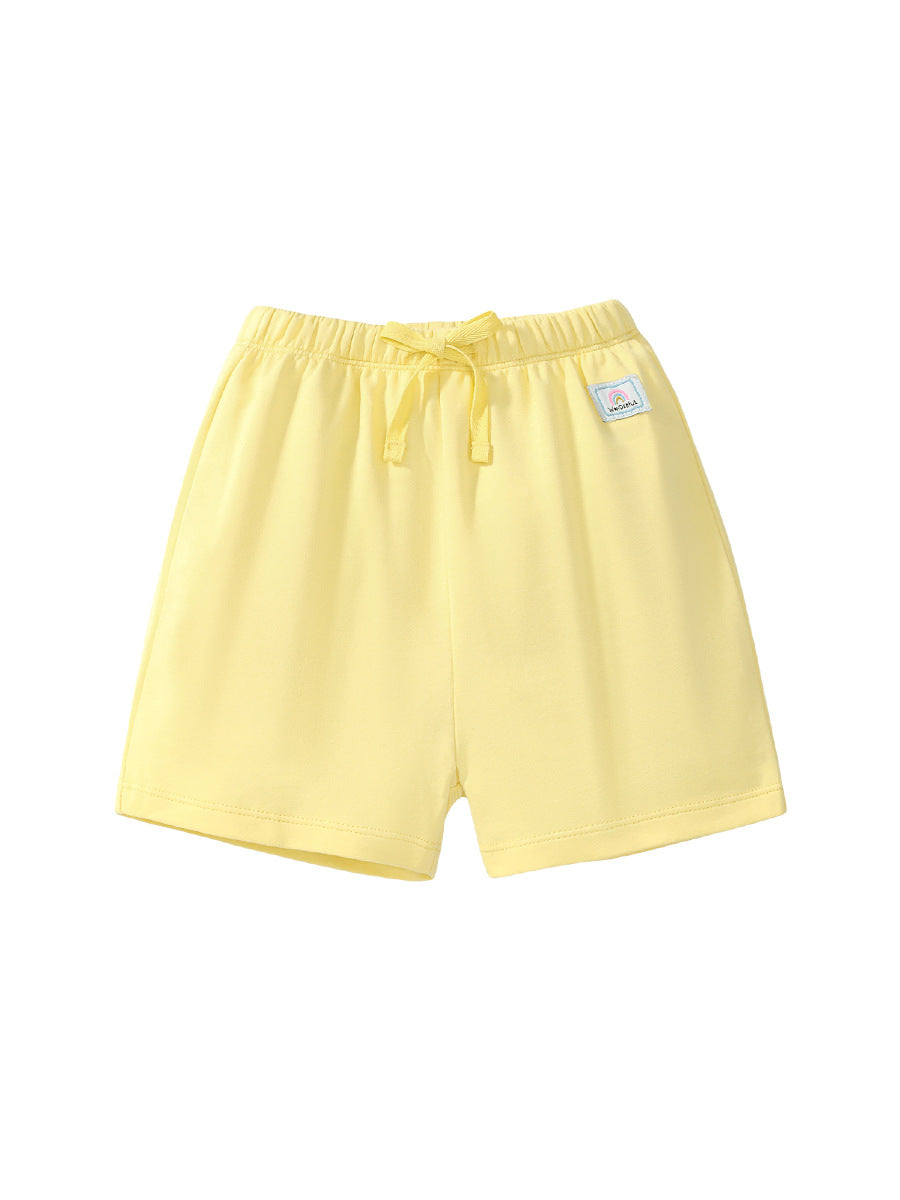 Girls solid color yellow capri pants with rainbow logo, made from soft cotton, perfect for summer wear.