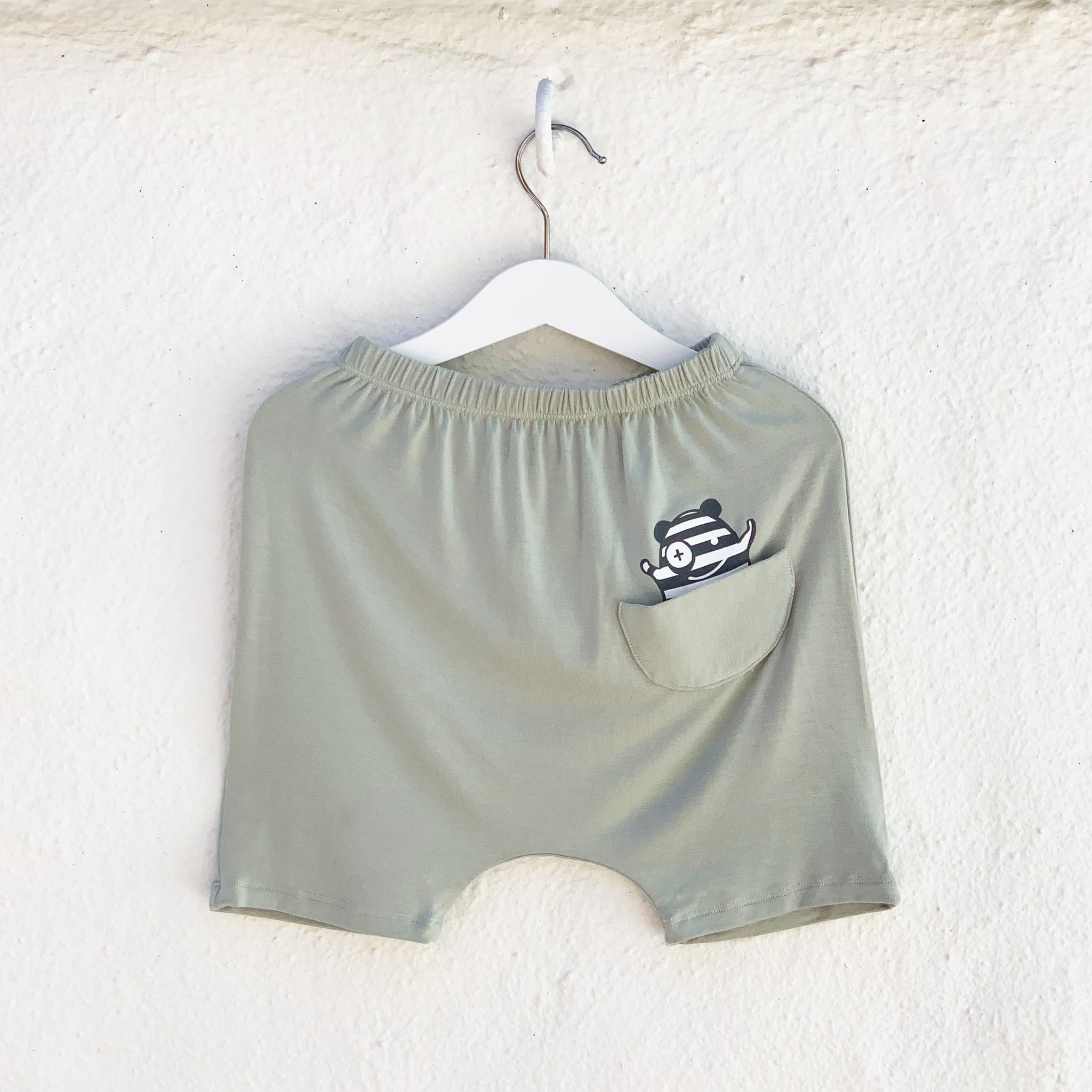 Hammer Shorties in Desert Sage featuring a monster peek-a-boo back pocket and drop crotch harem style, made from super soft fabric.