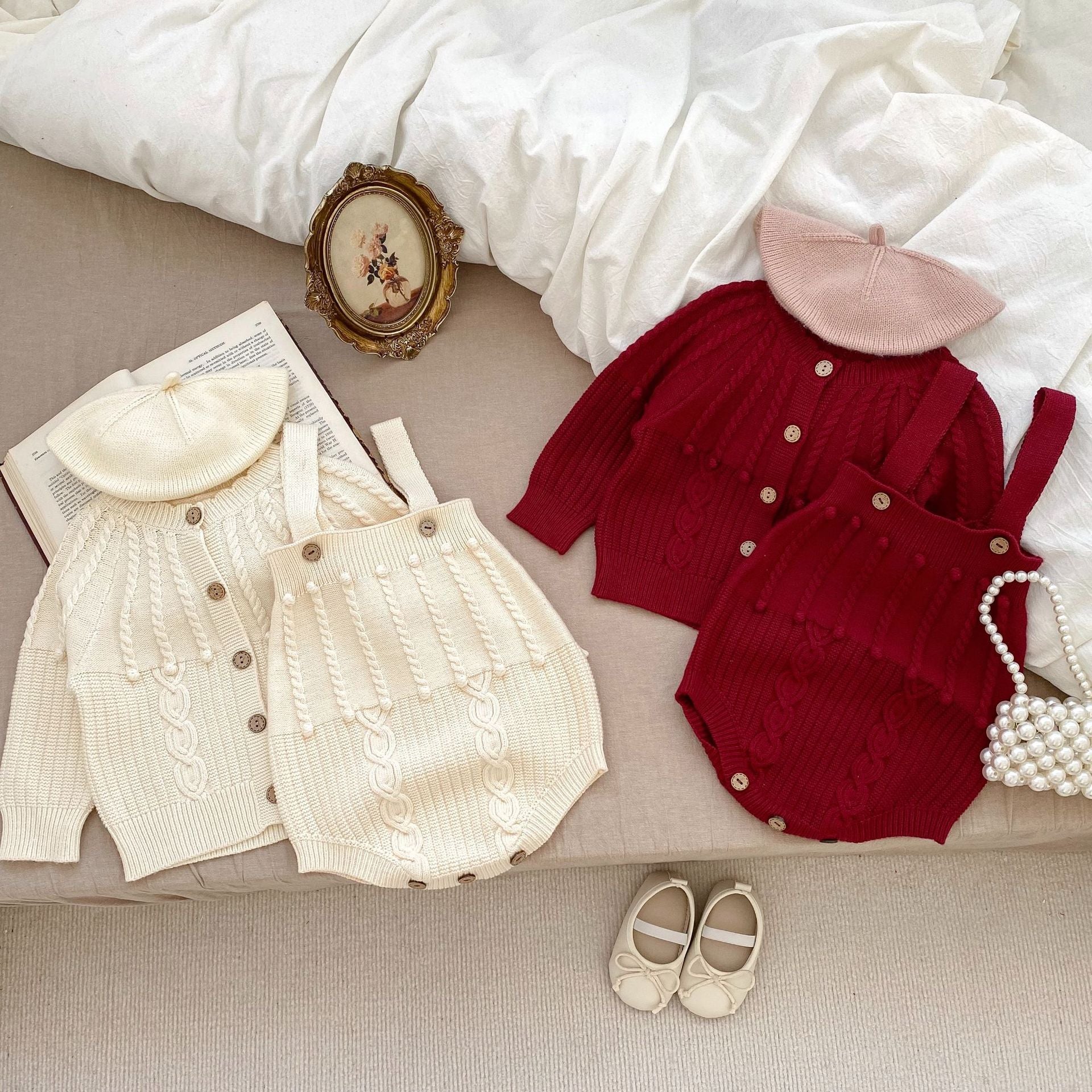 A handmade knitted cardigan set for baby girls, featuring a white and red color scheme, crafted from soft cotton material.