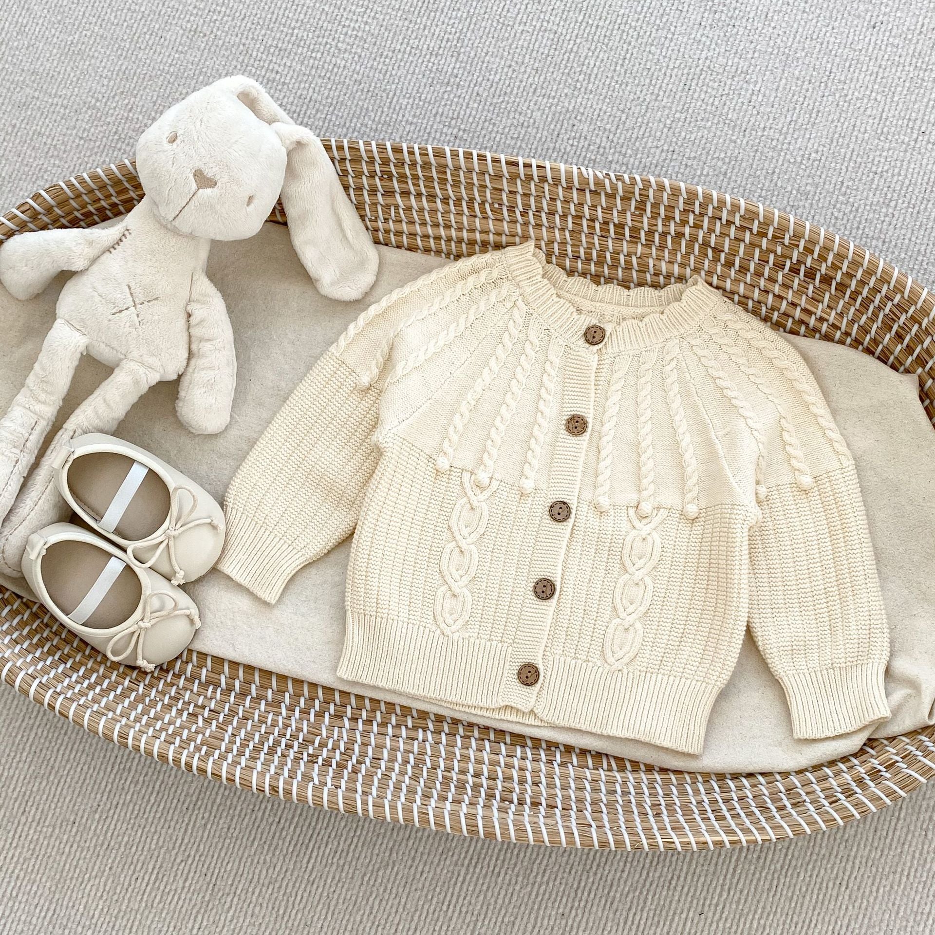 A handmade knitted cardigan set for baby girls, featuring a white and red color scheme, crafted from soft cotton material.