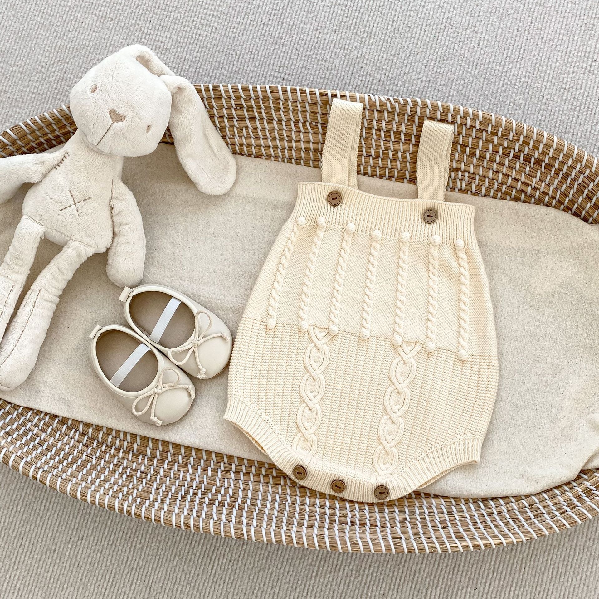 A handmade knitted cardigan set for baby girls, featuring a white and red color scheme, crafted from soft cotton material.