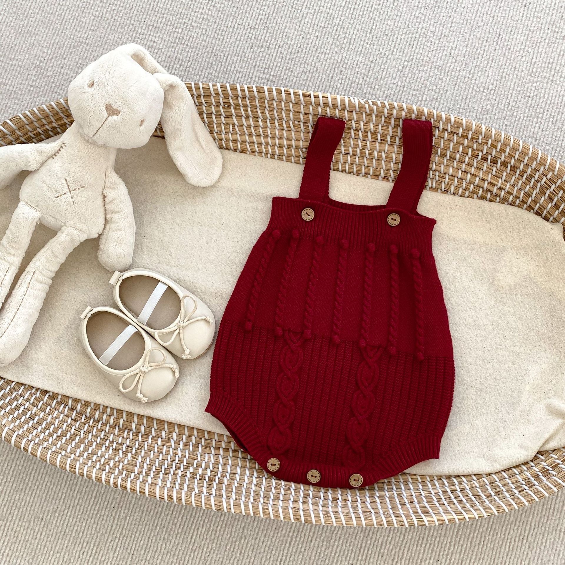 A handmade knitted cardigan set for baby girls, featuring a white and red color scheme, crafted from soft cotton material.