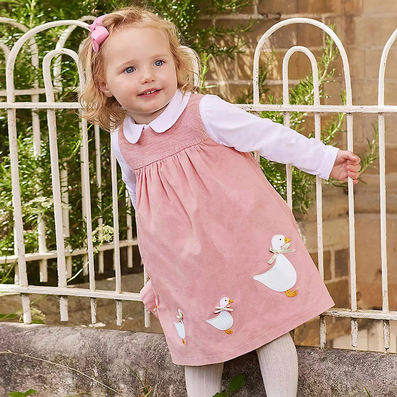 A vibrant sleeveless dress for girls featuring cartoon graphics in pink and blue colors, made from soft cotton fabric.