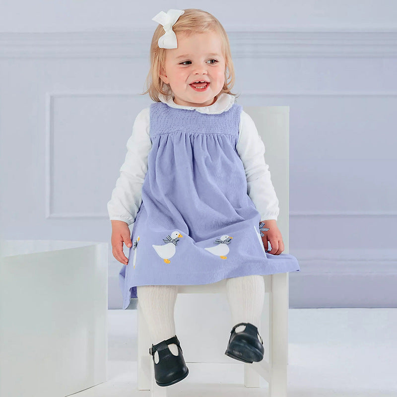 A vibrant sleeveless dress for girls featuring cartoon graphics in pink and blue colors, made from soft cotton fabric.