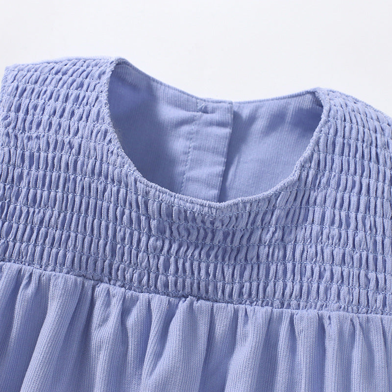 A vibrant sleeveless dress for girls featuring cartoon graphics in pink and blue colors, made from soft cotton fabric.