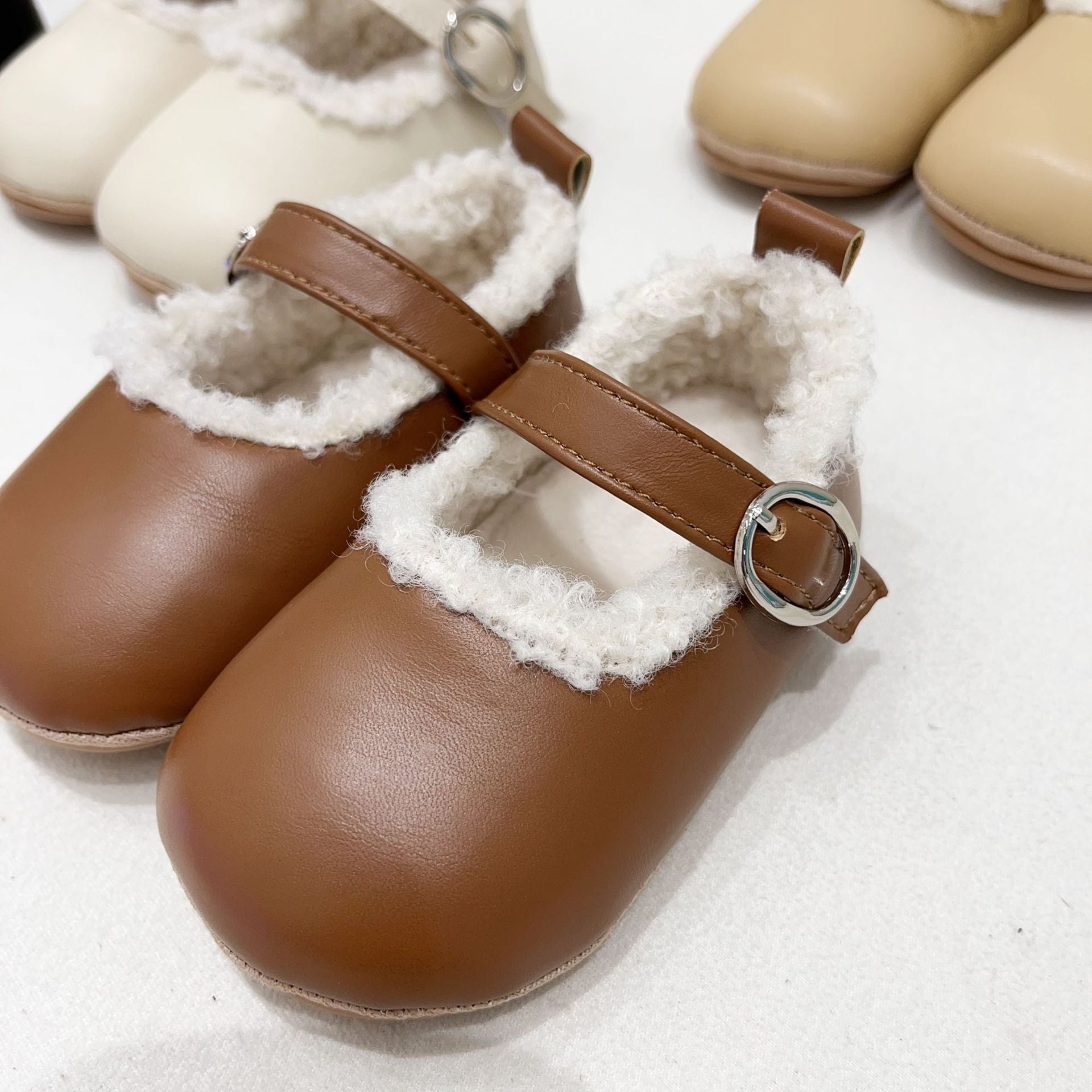 Infant baby girl plush warm anti-slip shoes in various colors including black, purple, yellow, beige, and brown, perfect for winter.