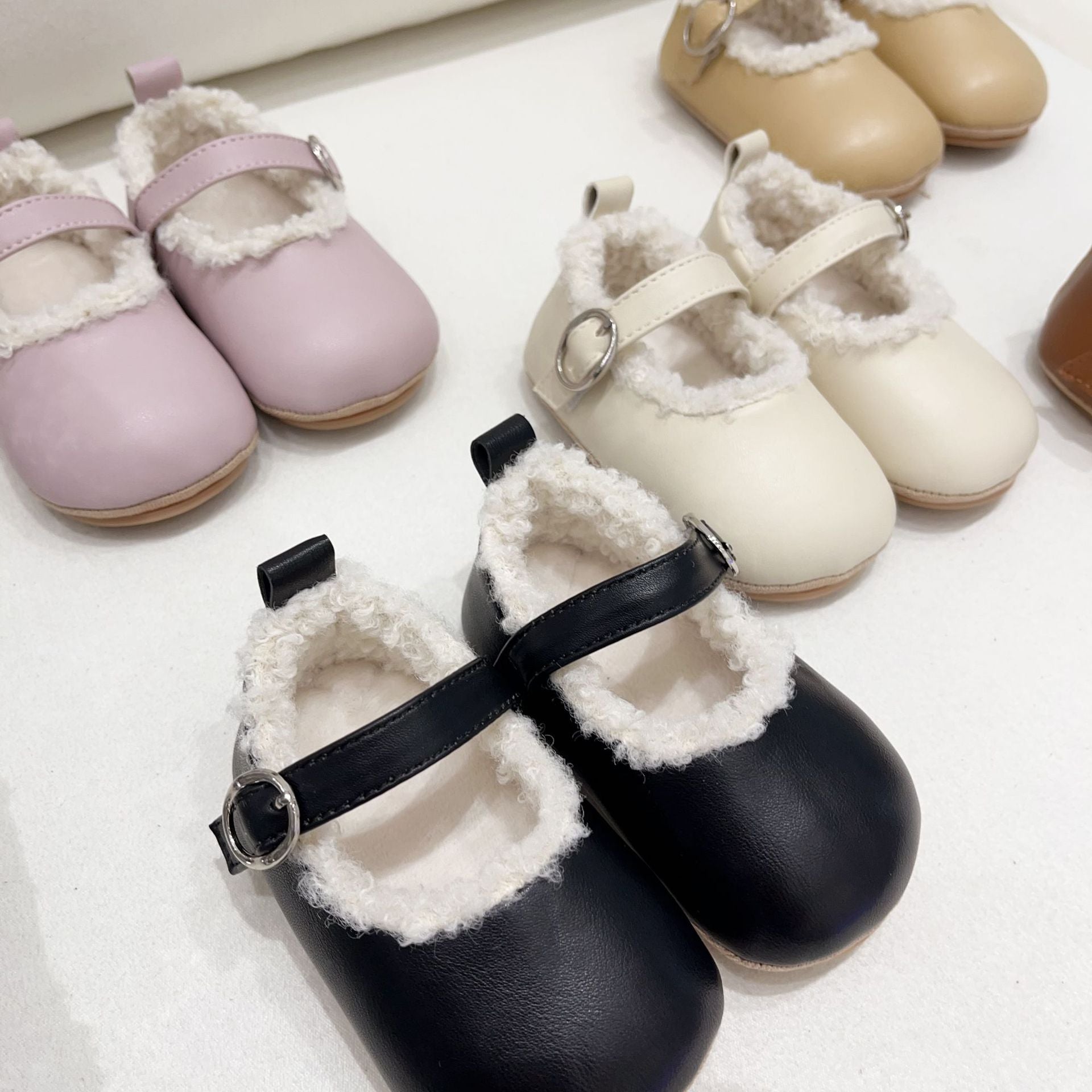Infant baby girl plush warm anti-slip shoes in various colors including black, purple, yellow, beige, and brown, perfect for winter.