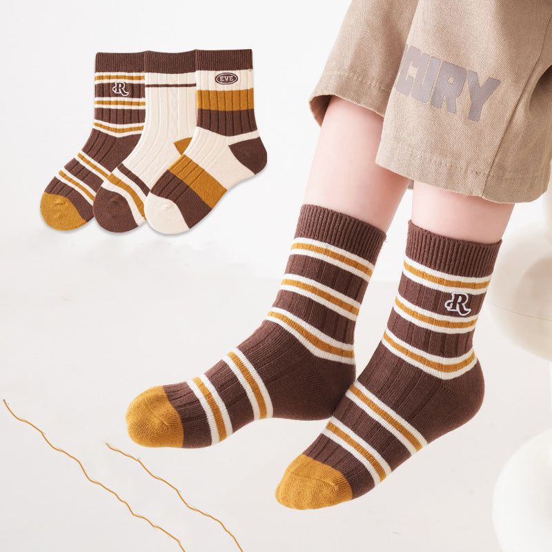 A colorful set of kids unisex crew socks featuring embroidery patterns, available in various colors and fun designs.