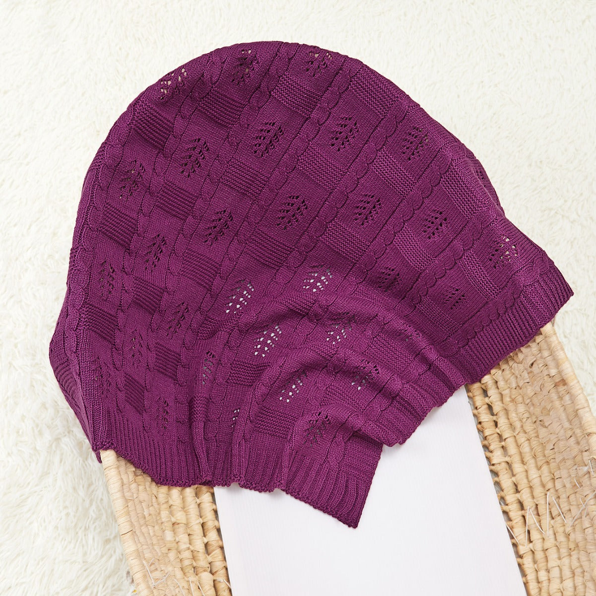 Knitted baby blanket featuring a hollow-out design in solid colors, perfect for all seasons.