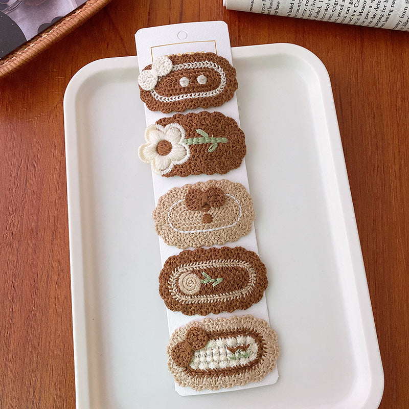 Korean-style versatile knit hair clip featuring a sweet floral design in vibrant colors, suitable for baby girls and girls aged 0-12 years.