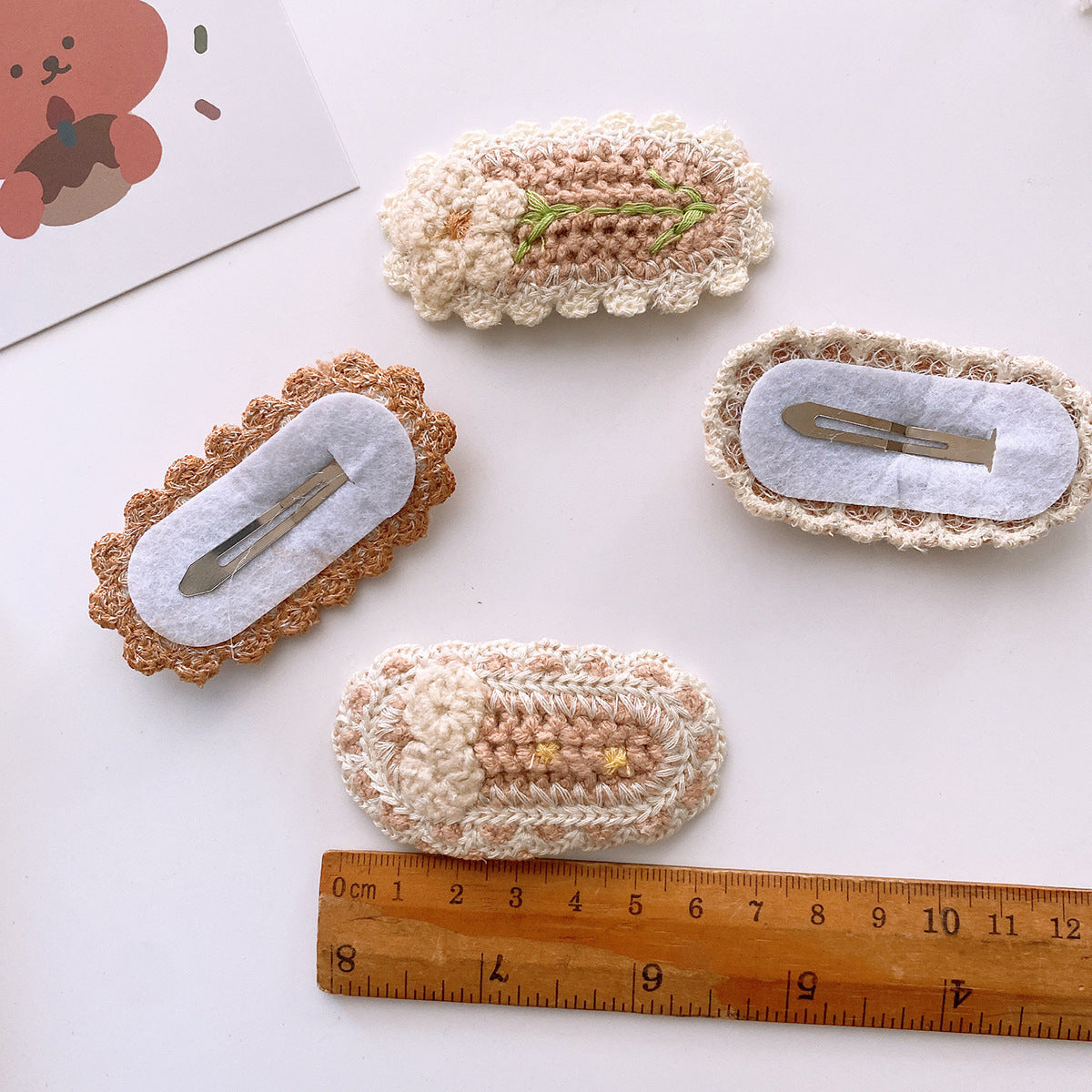Korean-style versatile knit hair clip featuring a sweet floral design in vibrant colors, suitable for baby girls and girls aged 0-12 years.
