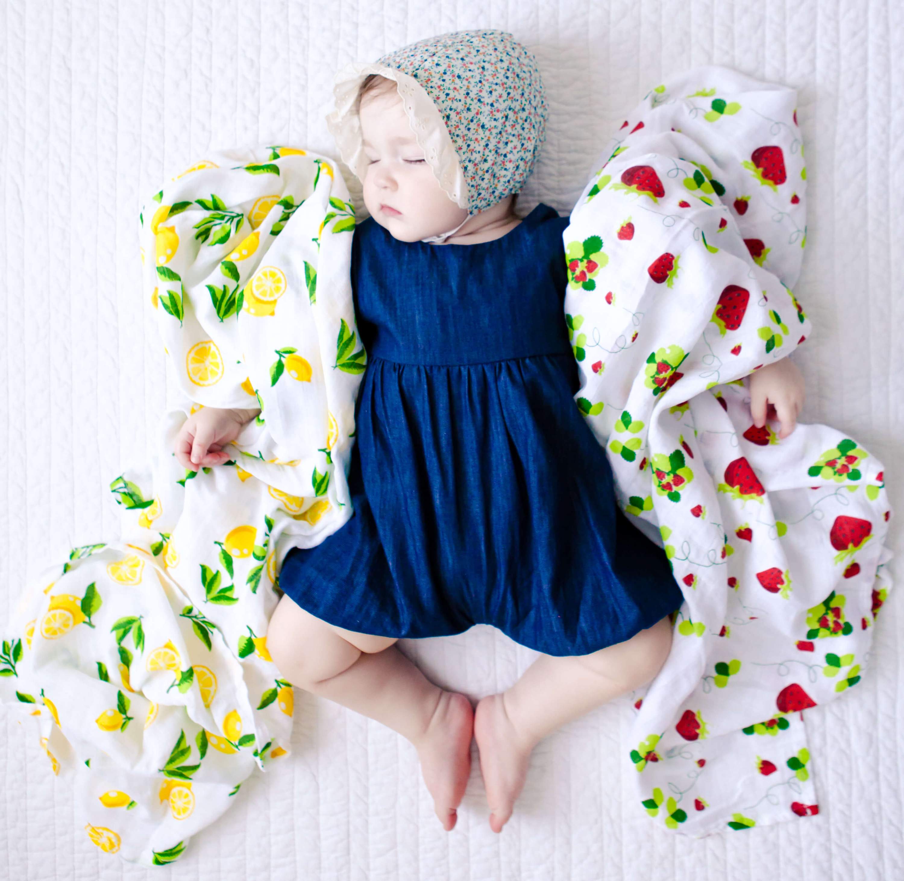 Muslin Swaddle Blanket Set featuring lemon and strawberry prints, showcasing soft and breathable fabric ideal for newborns.