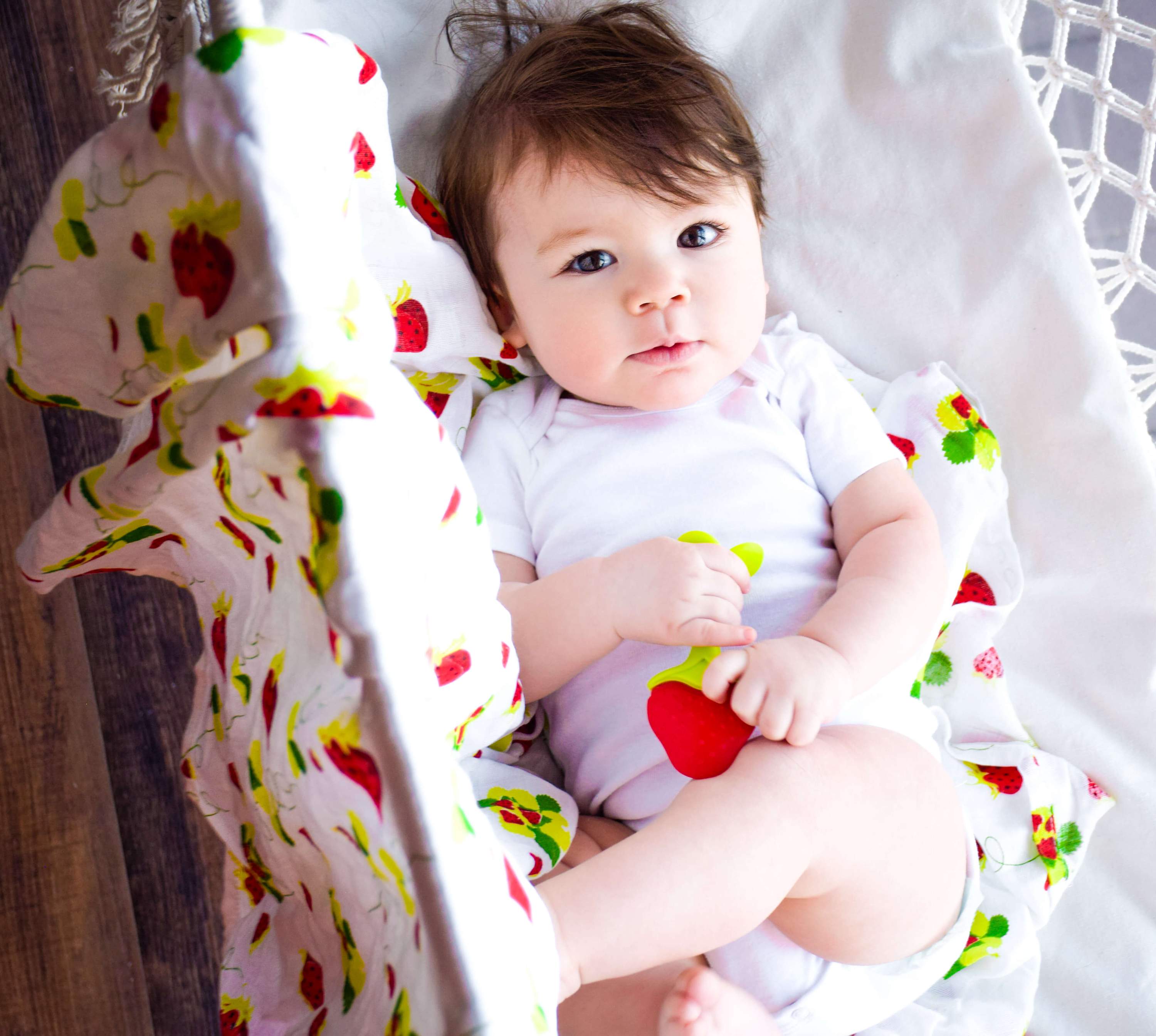 Muslin Swaddle Blanket Set featuring lemon and strawberry prints, showcasing soft and breathable fabric ideal for newborns.