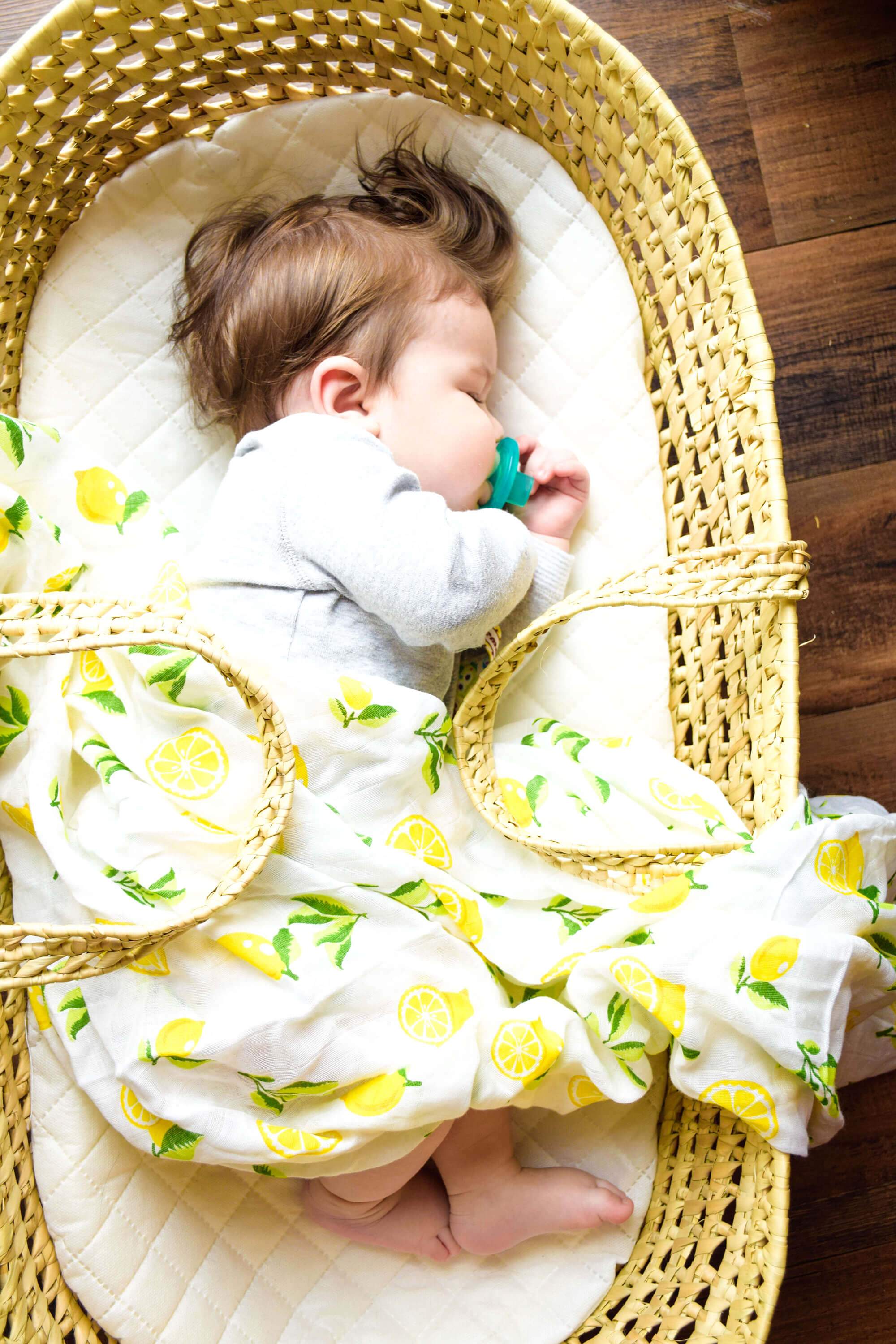 Muslin Swaddle Blanket Set featuring lemon and strawberry prints, showcasing soft and breathable fabric ideal for newborns.
