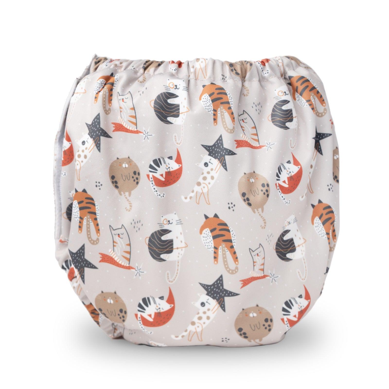 TITTI Pocket-Trainer washable diaper featuring a playful cat design, showcasing its waterproof exterior and adjustable Velcro closure.
