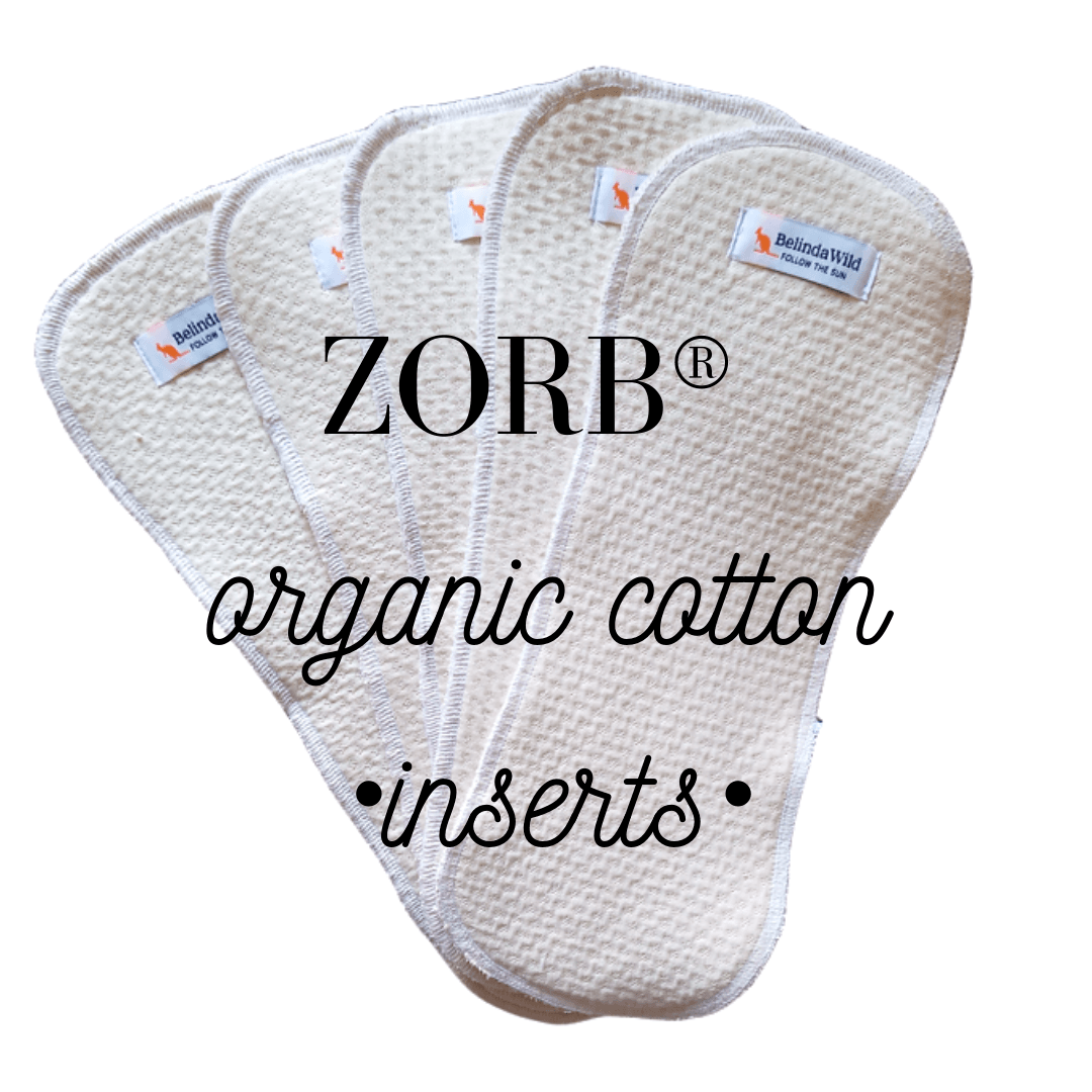 TITTI Pocket-Trainer washable diaper featuring a playful cat design, showcasing its waterproof exterior and adjustable Velcro closure.