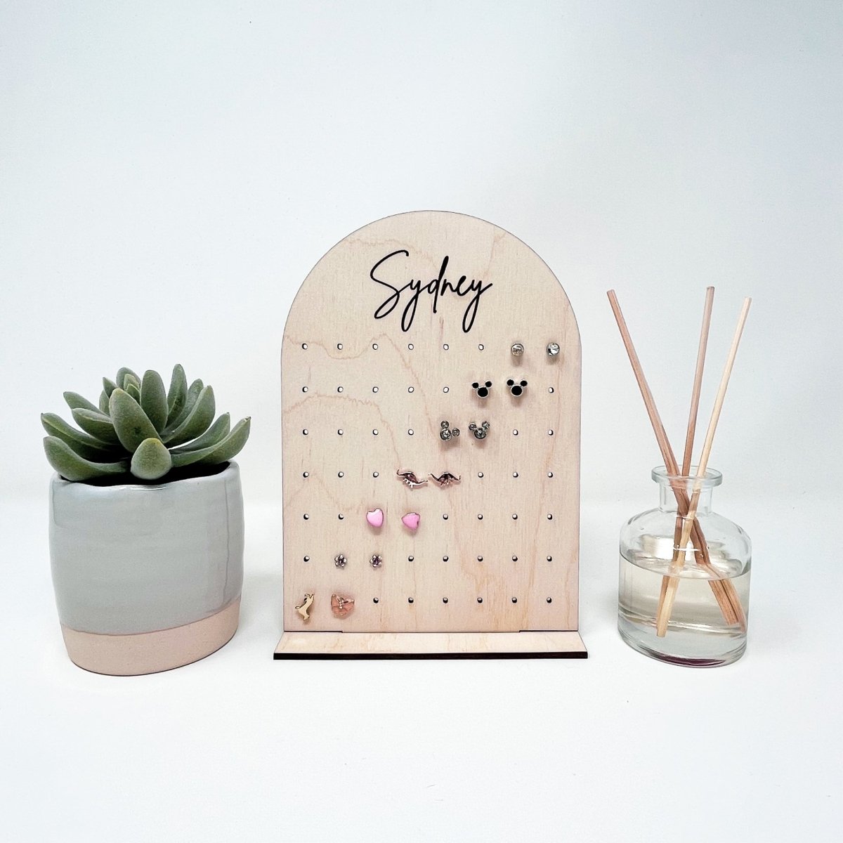 Earring display with plant and diffuser.