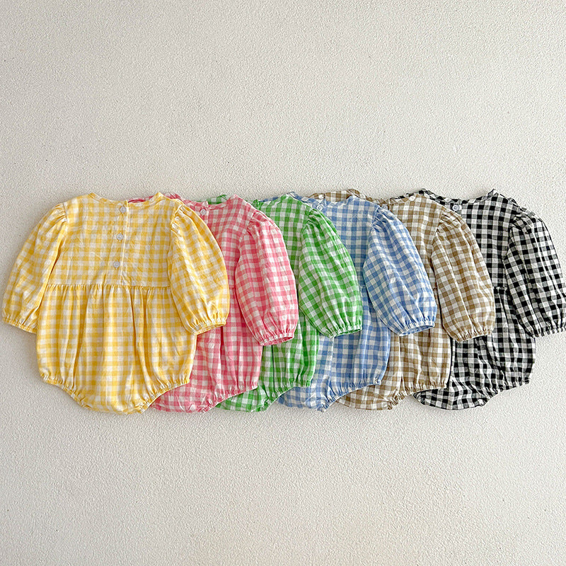 A collection of plaid pattern onesies for baby girls in various colors including black, pink, blue, green, yellow, and brown, made from soft cotton.