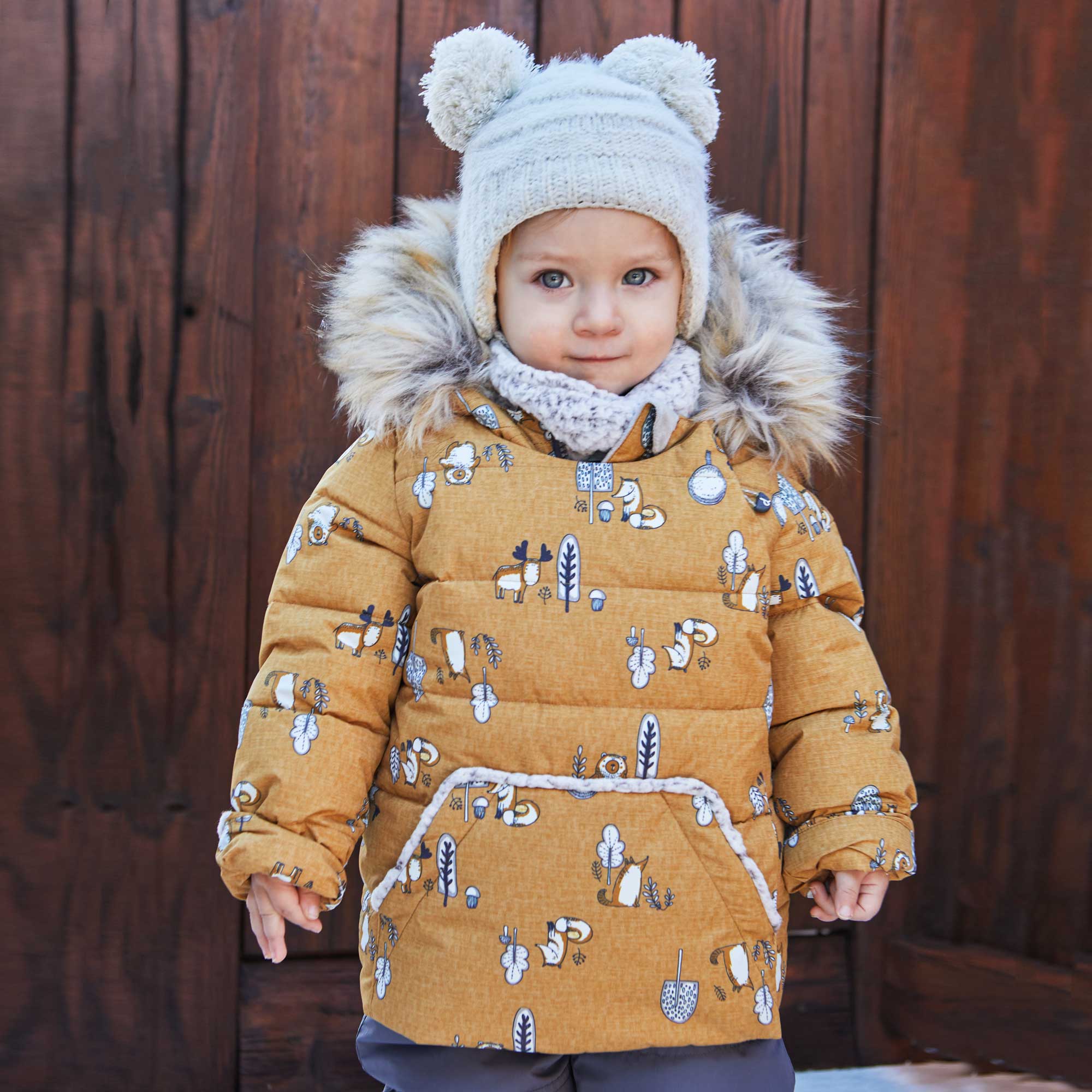 A vibrant yellow two-piece baby snowsuit featuring woodland animal prints, with solid pants and a printed jacket, designed for warmth and style.