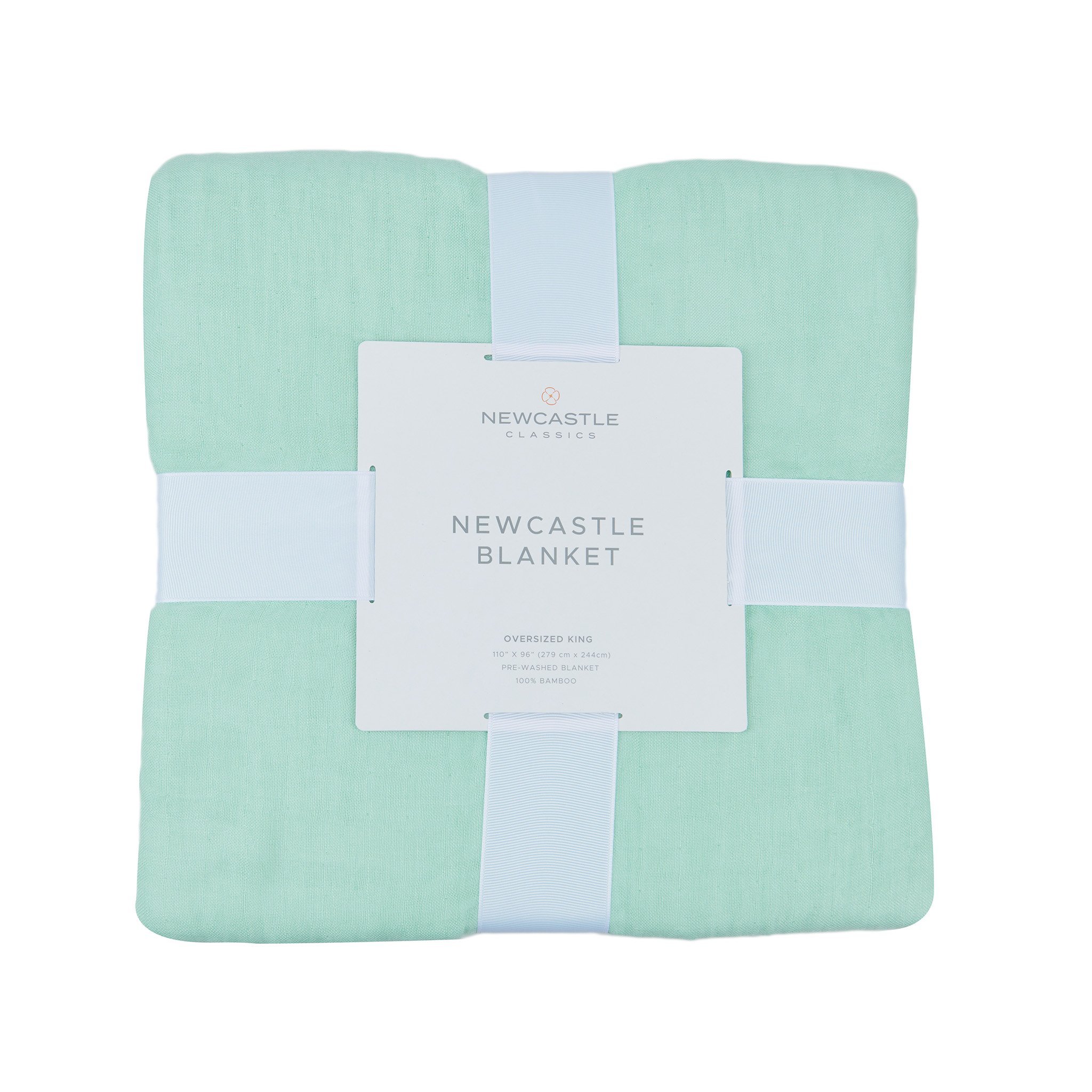 Seafoam green oversized queen bamboo bed blanket draped elegantly on a bed, showcasing its soft texture and beautiful color.