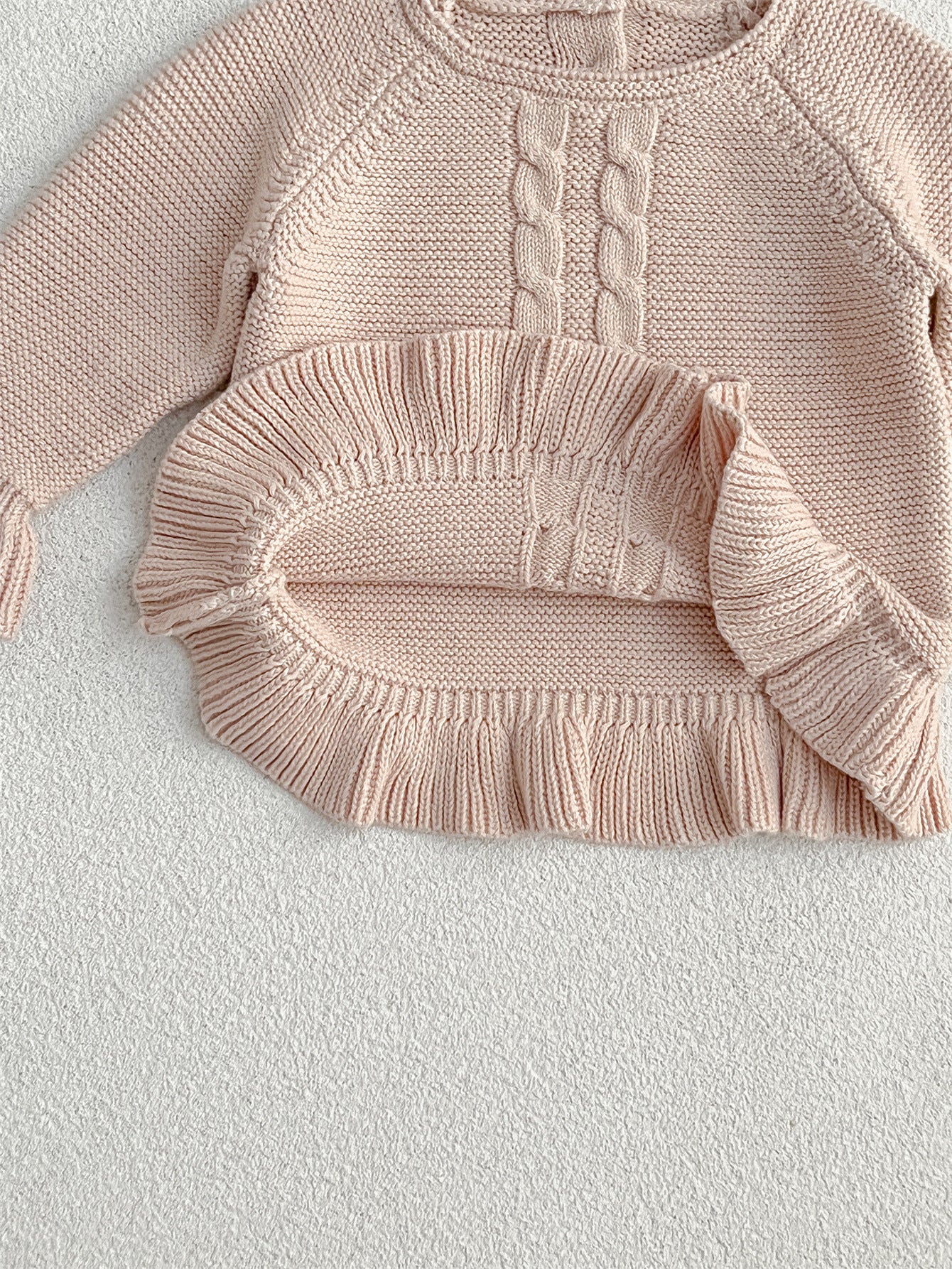 Khaki knitted pullover sweater for infant baby girls with long flared sleeves, made from soft cotton material.