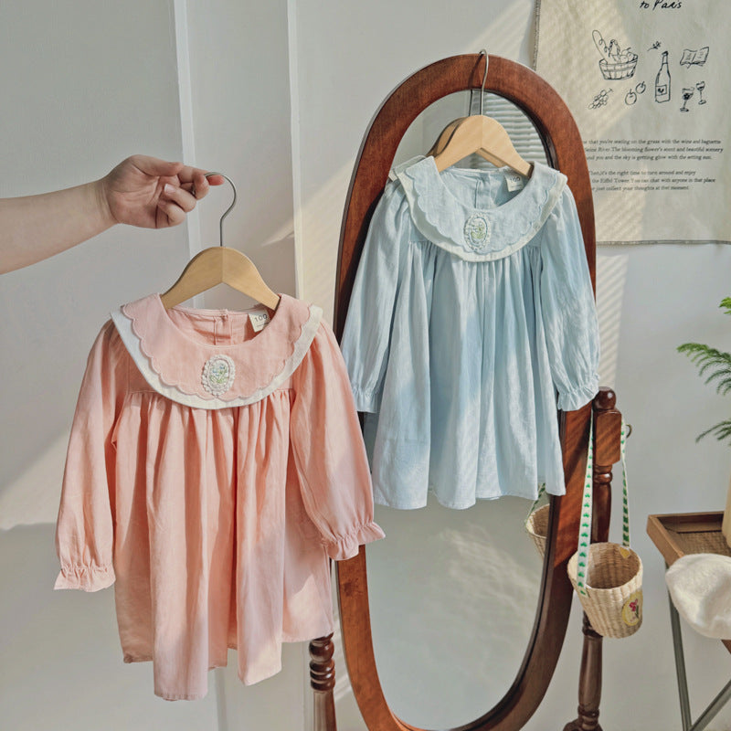 A stylish long-sleeve top for girls featuring a flower embroidered collar, available in pink and blue colors, made from soft cotton fabric.