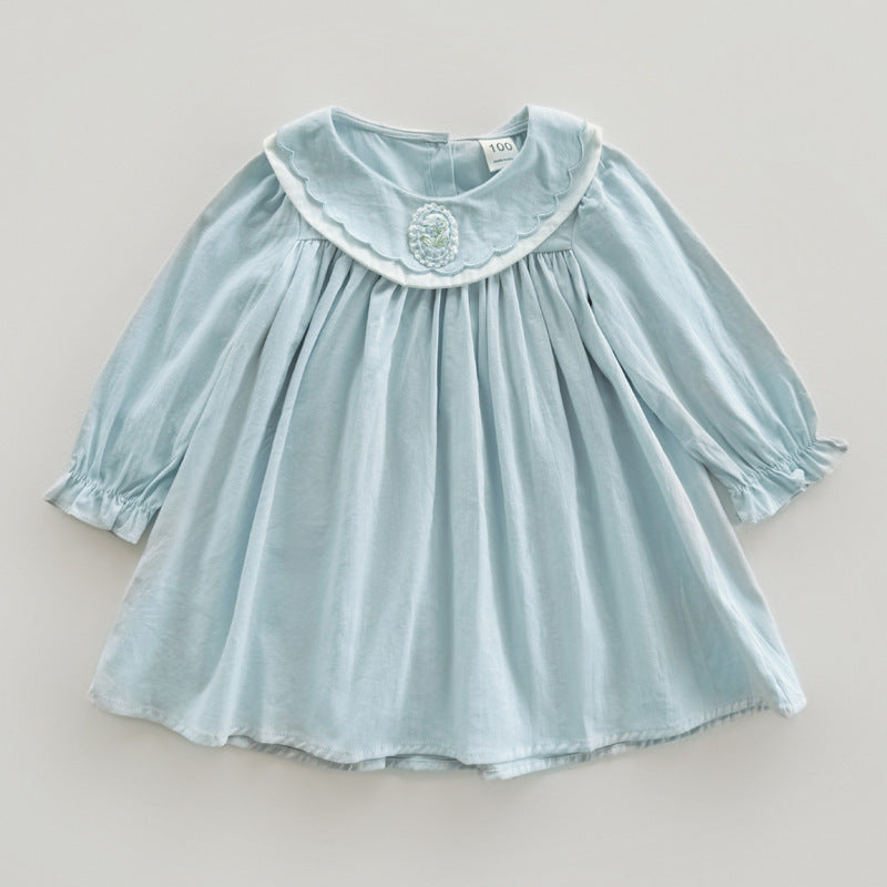 A stylish long-sleeve top for girls featuring a flower embroidered collar, available in pink and blue colors, made from soft cotton fabric.