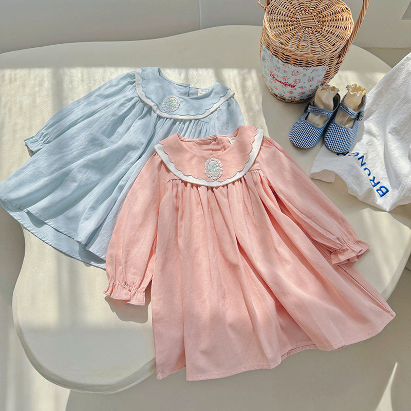 A stylish long-sleeve top for girls featuring a flower embroidered collar, available in pink and blue colors, made from soft cotton fabric.