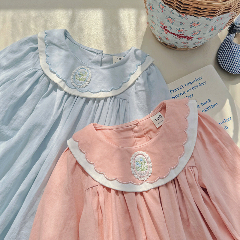 A stylish long-sleeve top for girls featuring a flower embroidered collar, available in pink and blue colors, made from soft cotton fabric.