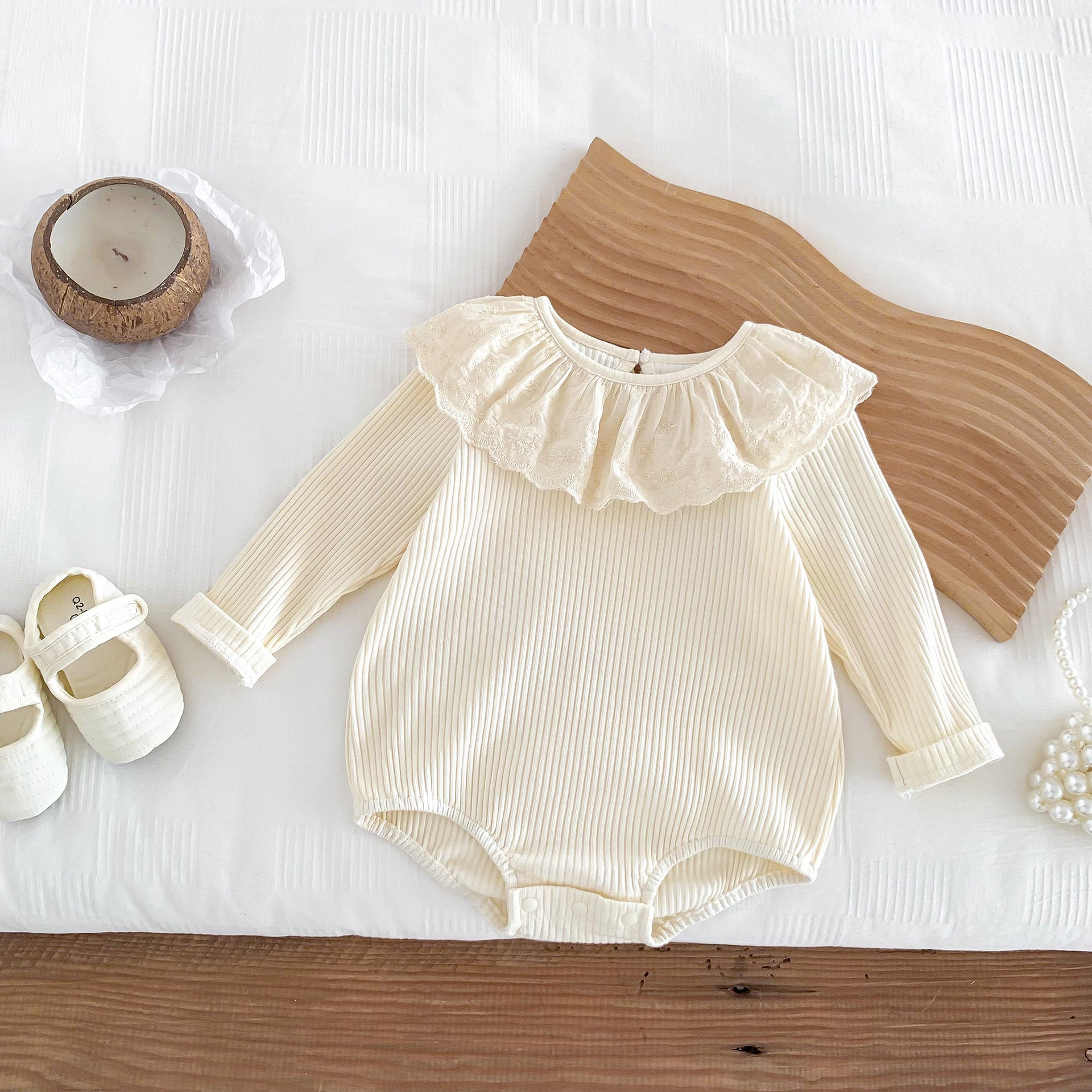 Solid color ruffle neck soft cotton onesies in white and apricot for baby girls, showcasing the elegant design and soft fabric.