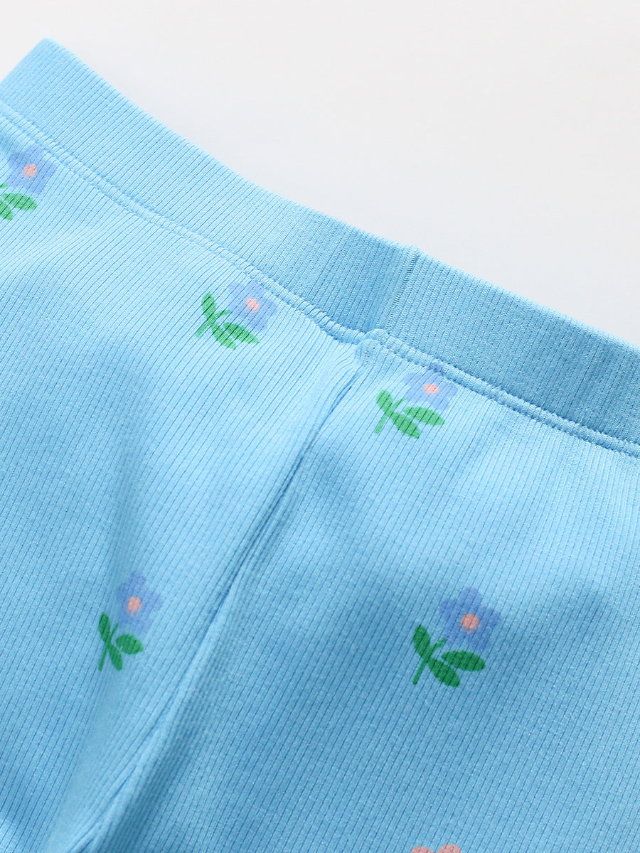 A blue long-sleeve top for girls featuring a colorful cartoon flowers pattern, made from cotton and polyester, perfect for spring and autumn wear.