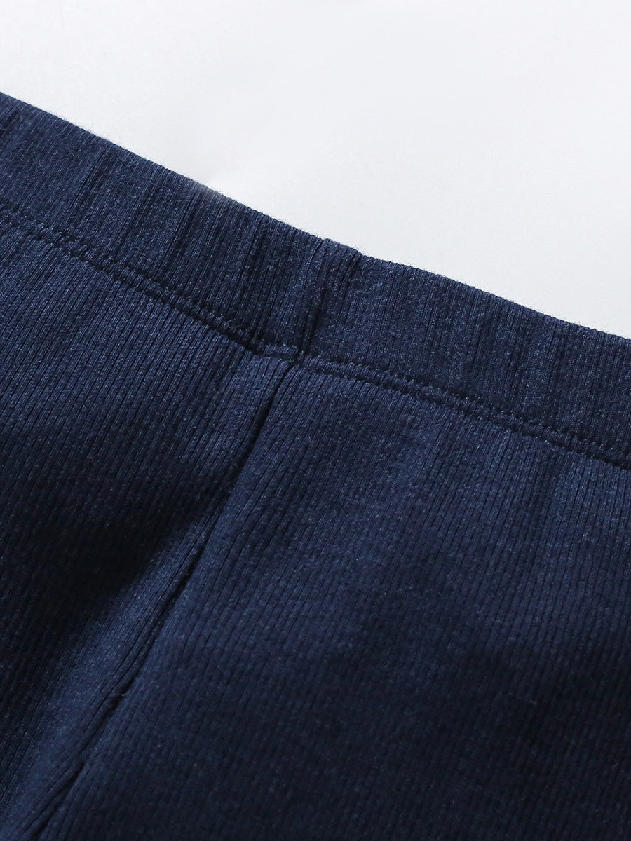 A white long-sleeve crew neck top for girls featuring a colorful cartoon unicorn pattern, perfect for spring and autumn wear.