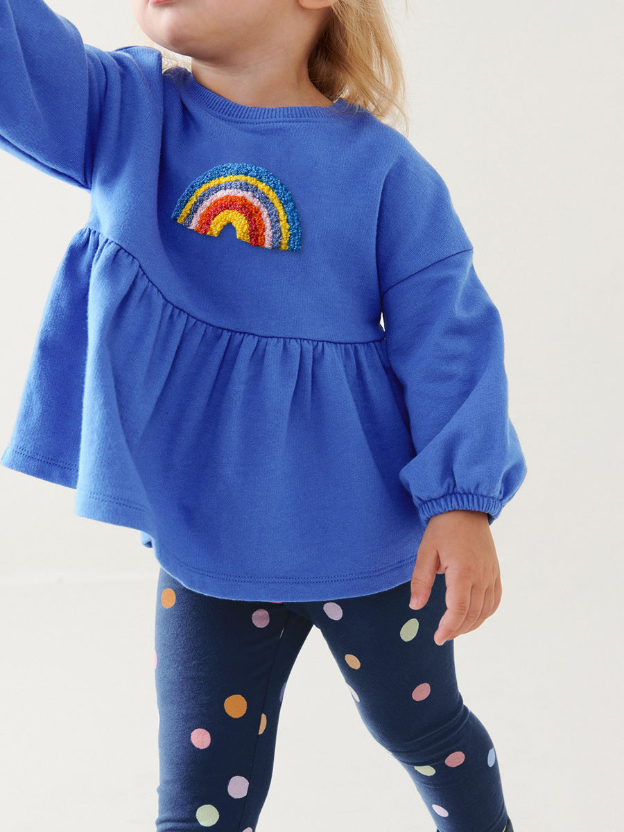 A blue long-sleeve top for girls featuring a cute rainbow embroidery pattern, perfect for spring and autumn wear.