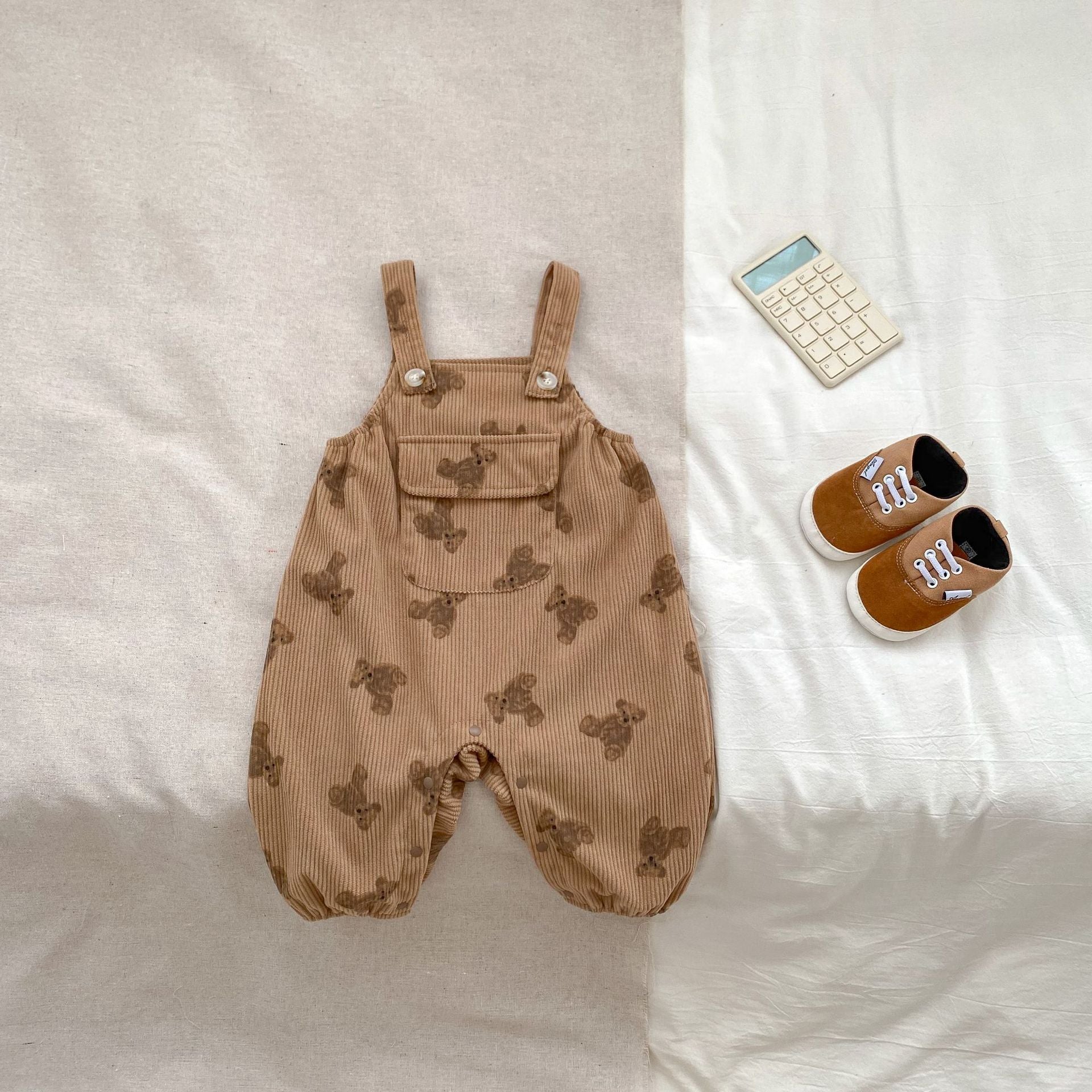 Adorable unisex baby corduroy overalls in khaki and brown with a cute teddy cartoon pattern, perfect for spring and autumn.