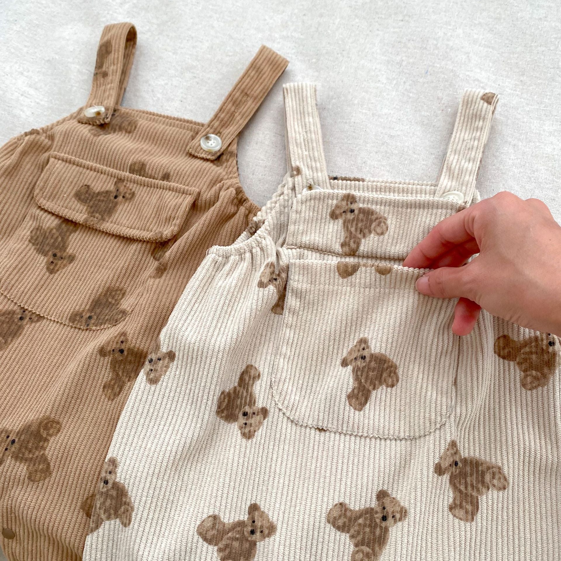 Adorable unisex baby corduroy overalls in khaki and brown with a cute teddy cartoon pattern, perfect for spring and autumn.
