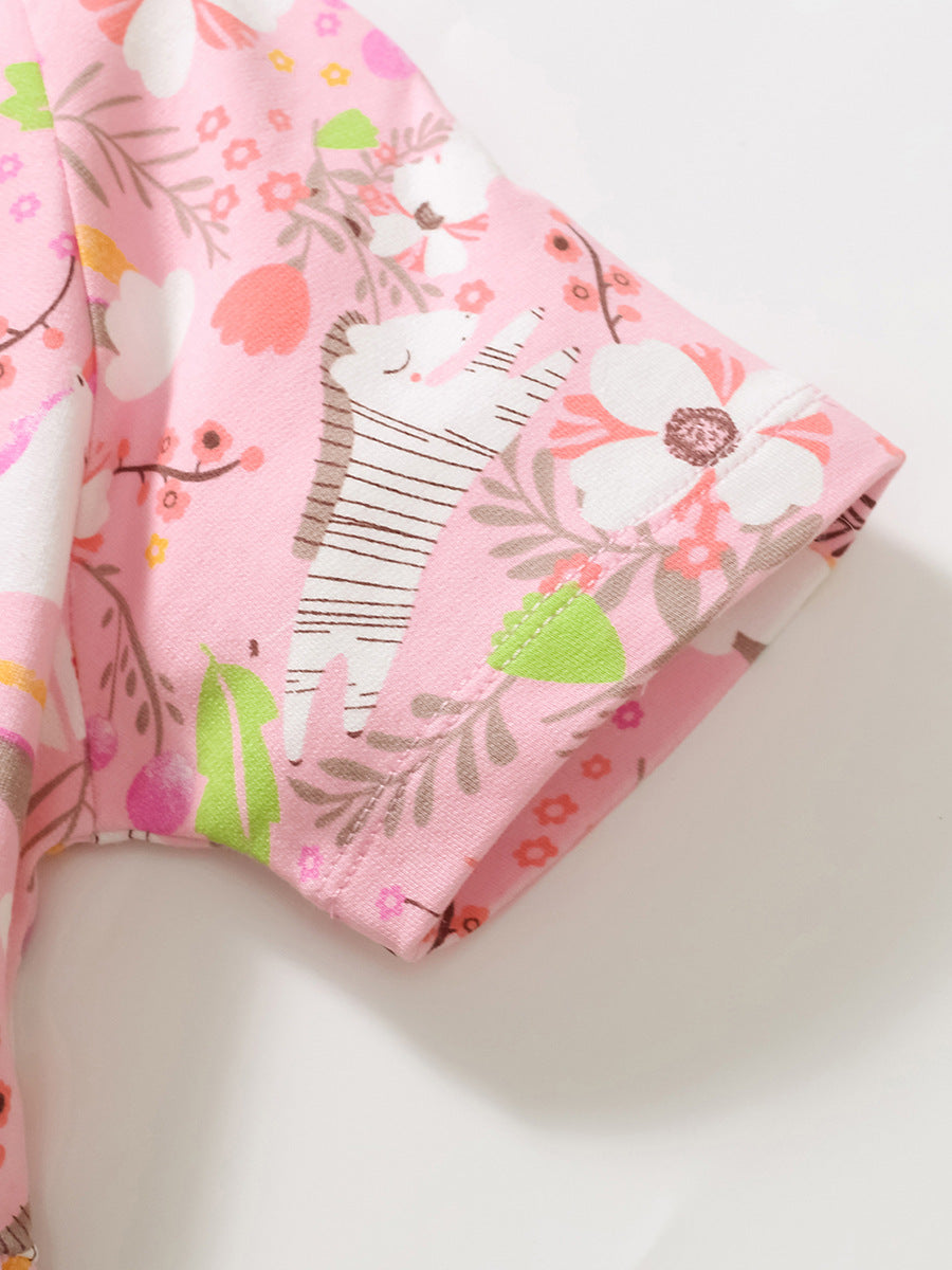 A vibrant pink short-sleeved top for baby girls featuring rainbow animal prints and floral designs, perfect for spring and summer wear.