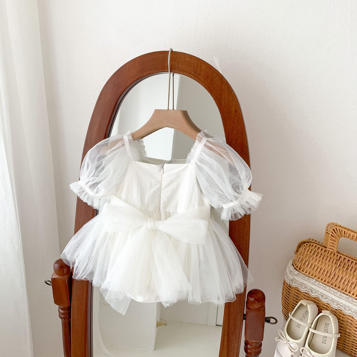 A cute Spring and Summer Baby Girls Short Sleeves Solid Color Mesh Dress in white and pink, perfect for warm weather.