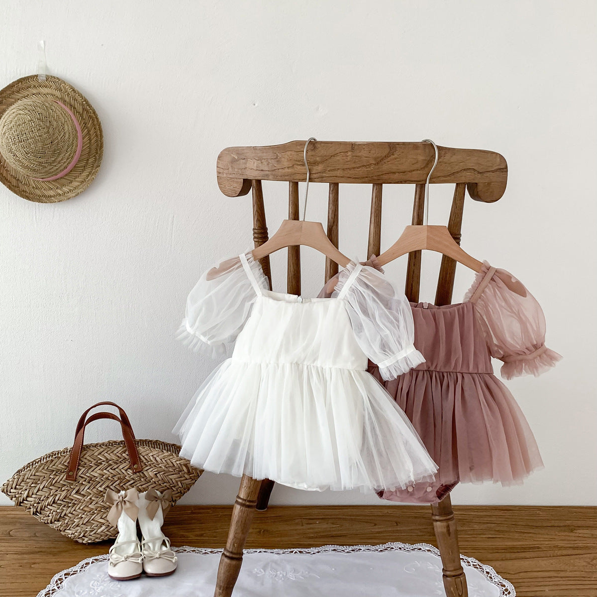A cute Spring and Summer Baby Girls Short Sleeves Solid Color Mesh Dress in white and pink, perfect for warm weather.
