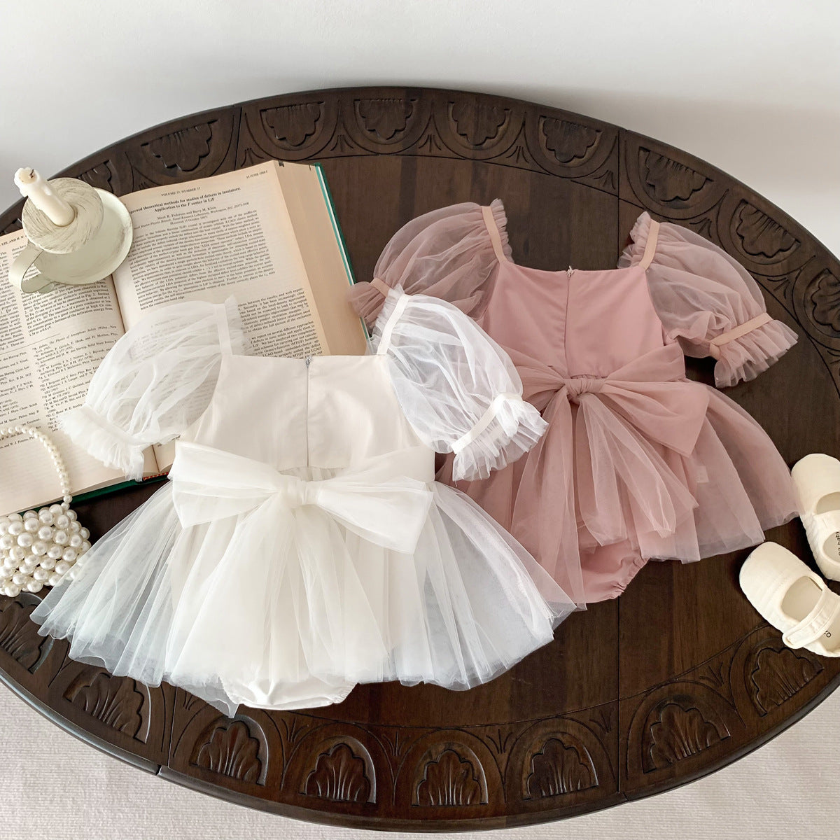 A cute Spring and Summer Baby Girls Short Sleeves Solid Color Mesh Dress in white and pink, perfect for warm weather.
