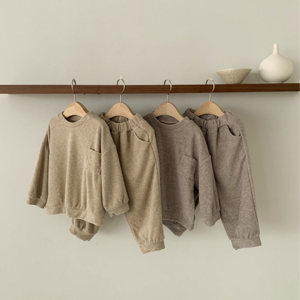 Spring Baby and Kids Unisex Solid Color Pullover Top in apricot and coffee colors, featuring a pocket and made from soft viscose fiber.