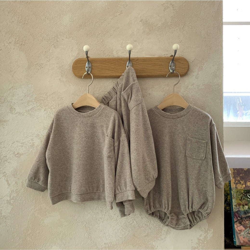 Spring Baby and Kids Unisex Solid Color Pullover Top in apricot and coffee colors, featuring a pocket and made from soft viscose fiber.