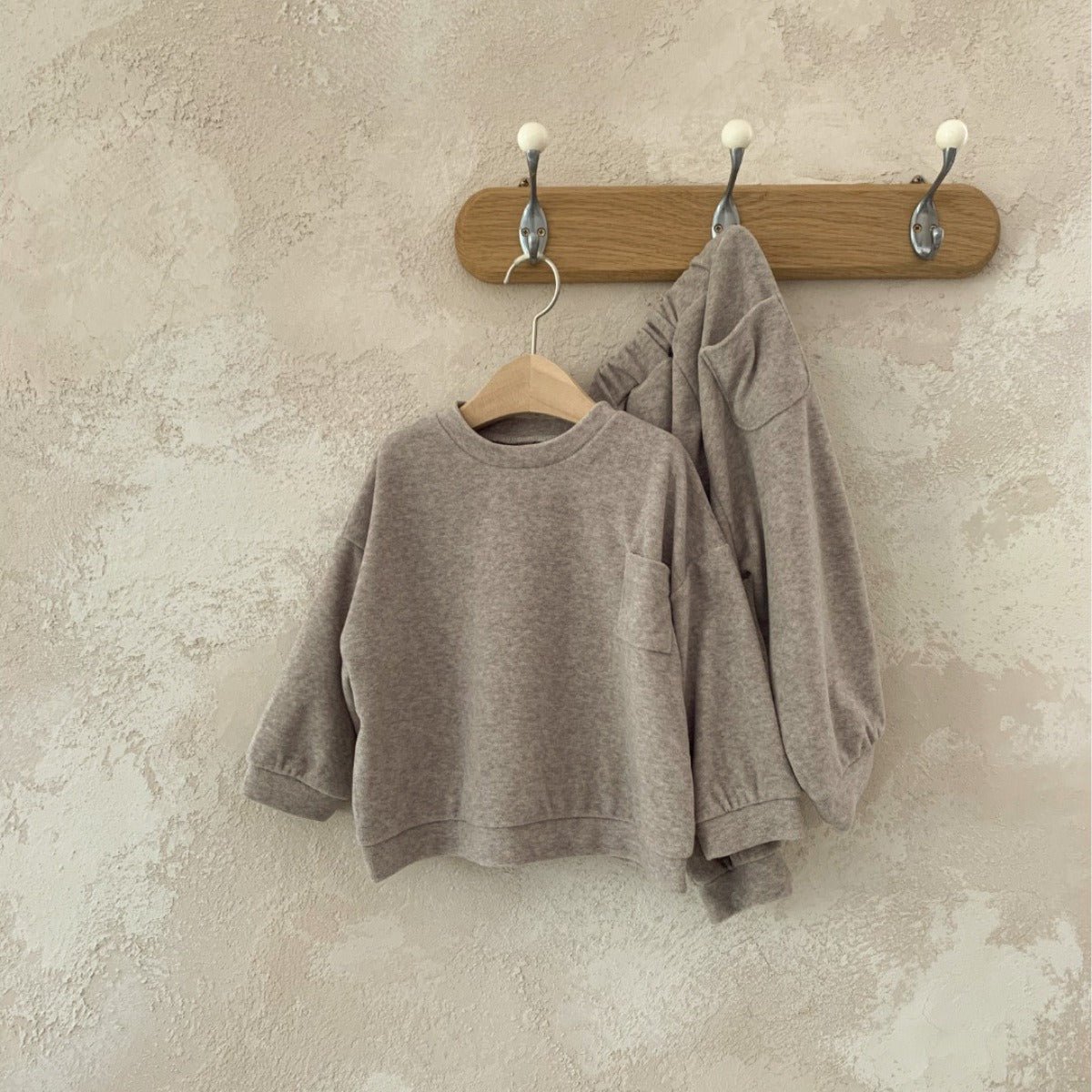 Spring Baby and Kids Unisex Solid Color Pullover Top in apricot and coffee colors, featuring a pocket and made from soft viscose fiber.