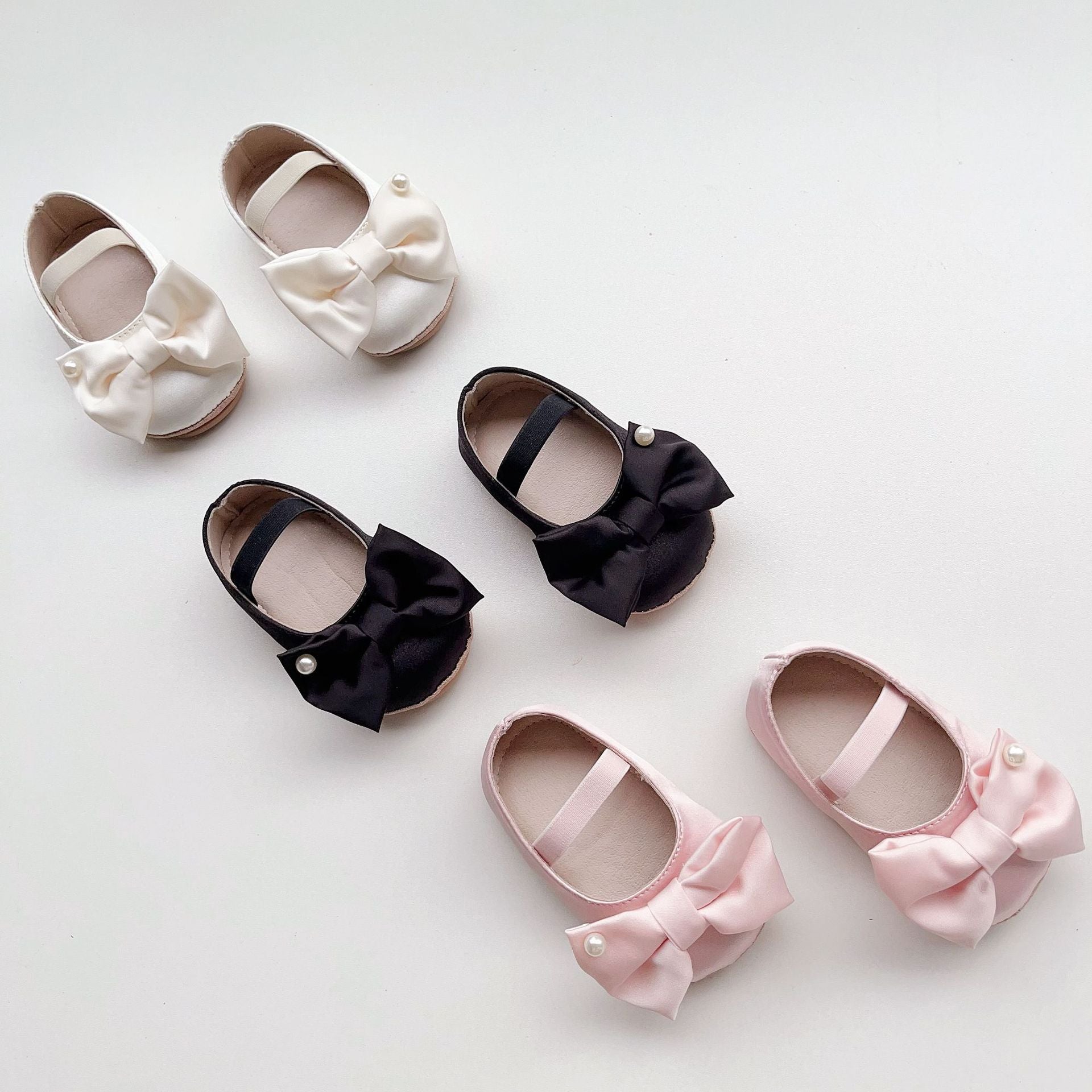 Spring Baby Girl Big Bow Toddler Soft-Sole Anti-Slip Walking Shoes in white, black, and pink colors with a stylish big bow.