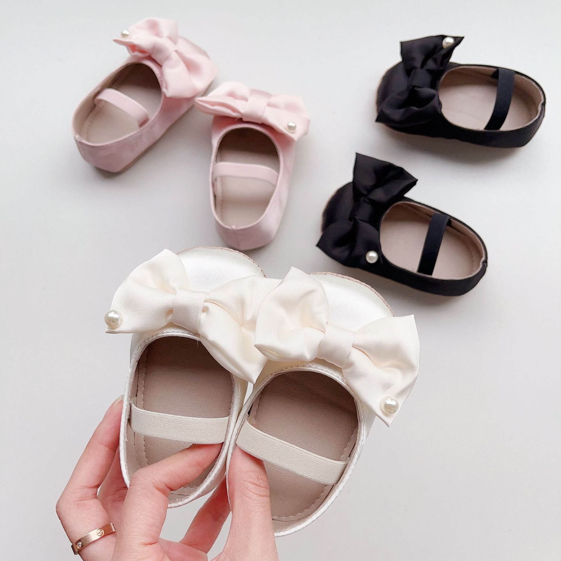 Spring Baby Girl Big Bow Toddler Soft-Sole Anti-Slip Walking Shoes in white, black, and pink colors with a stylish big bow.