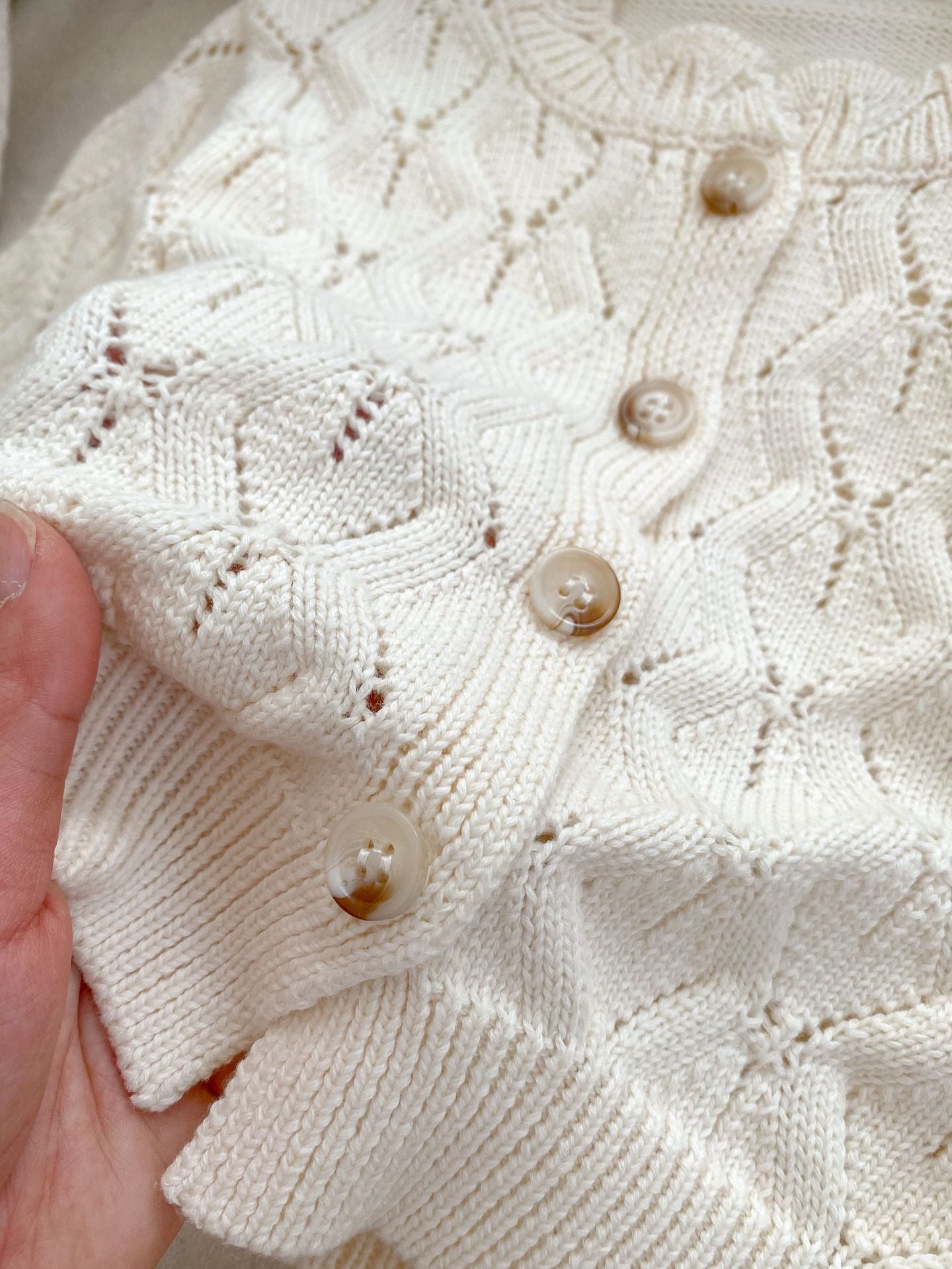 Beige hollow out knitting pattern cardigan sweater for baby girls, made of soft cotton, perfect for spring and summer wear.