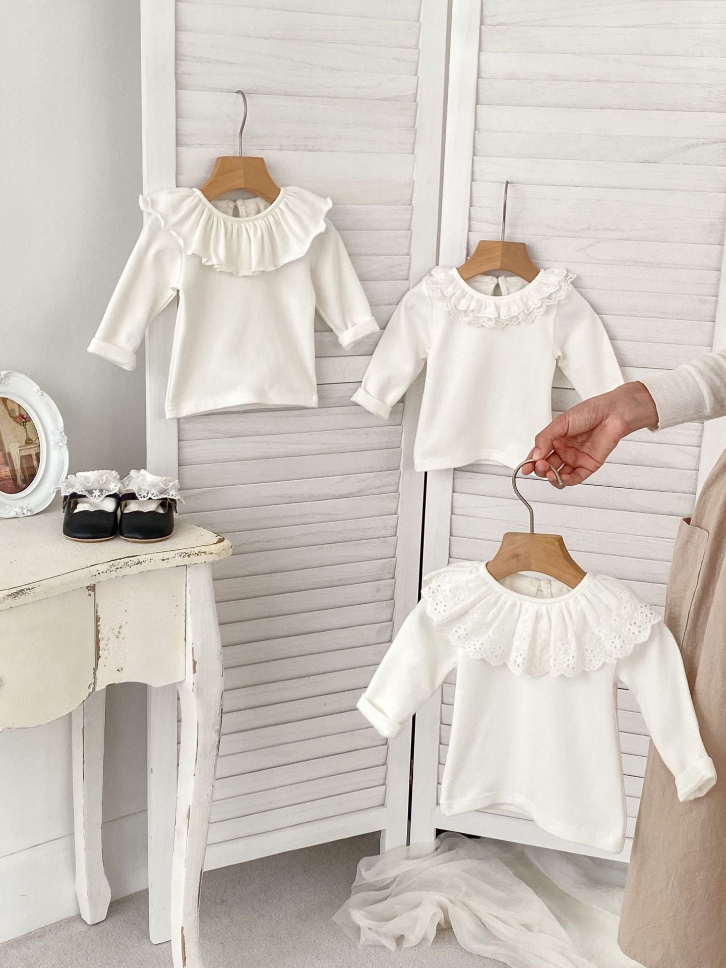 Baby girls' long sleeve shirt with doll collar in white, ivory, and beige colors, made from soft cotton fabric.