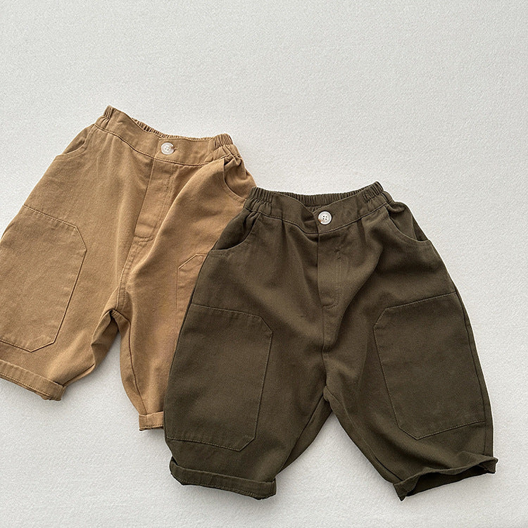A pair of unisex plain solid color cotton washed pants in green and khaki, suitable for kids of all ages.