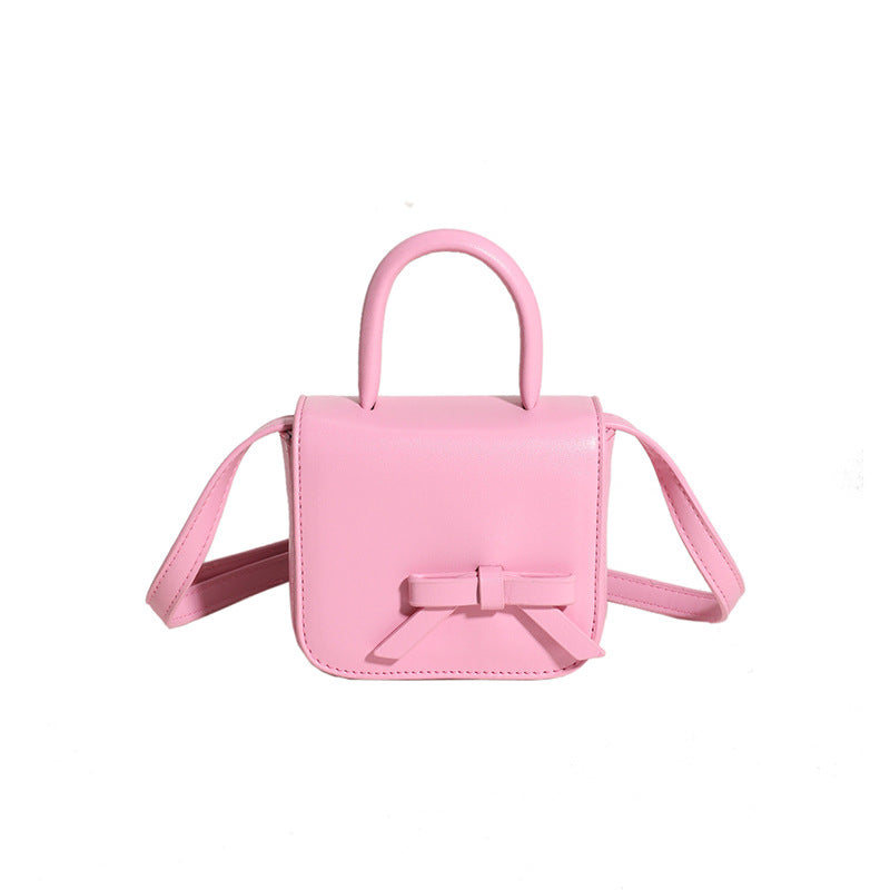 Stylish Creative Carry-On Girls’ Portable Mini Bow Princess Crossbody bag in white, black, pink, and silver colors with a cute bow design.
