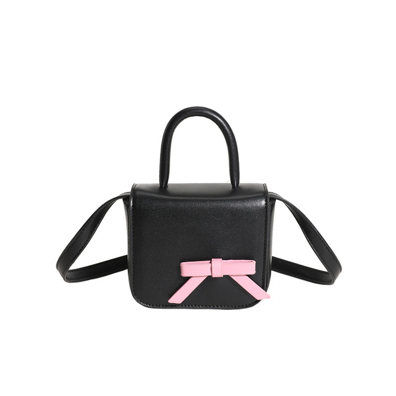 Stylish Creative Carry-On Girls’ Portable Mini Bow Princess Crossbody bag in white, black, pink, and silver colors with a cute bow design.